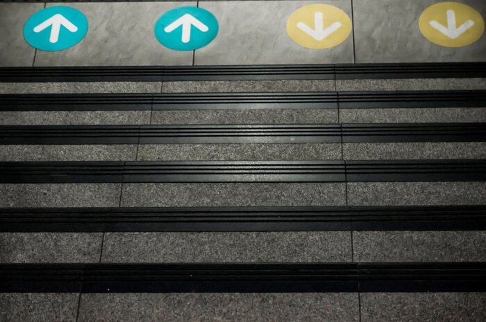 Sticker Colored Arrow Signs Sticker Placed on The Floor in front of Stairs