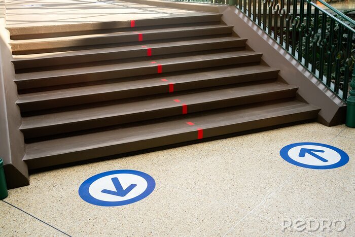 Sticker Epidemic protection measures in shops, shopping malls or centres floor blue circle stickers with arrow . Social Distance Shopping. Life after virus. Secure marking of lines on floor for directions,