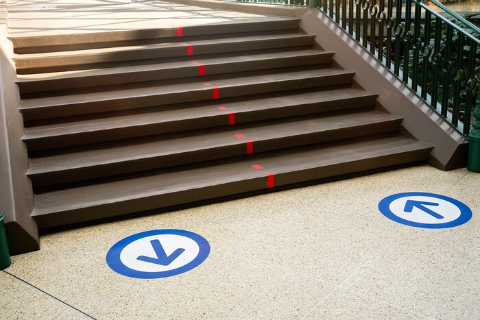 Sticker Epidemic protection measures in shops, shopping malls or centres floor blue circle stickers with arrow . Social Distance Shopping. Life after virus. Secure marking of lines on floor for directions,