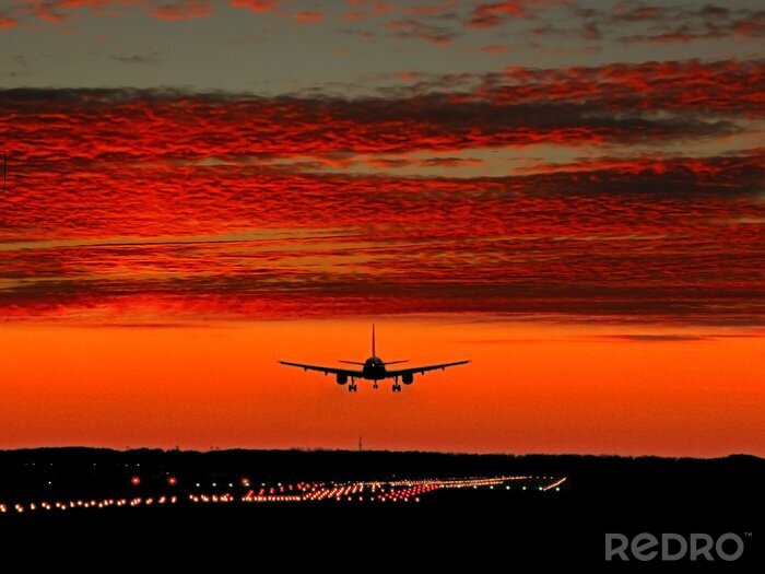 Sticker Flugzeuglandung und roter Himmel