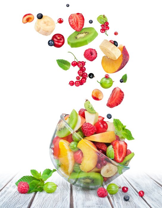Sticker Fruit salad in glass bowl with ingredients in the air on white w
