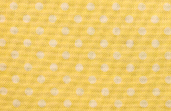 Sticker Gelbes Tischtuch mit weißen Tupfen Makro