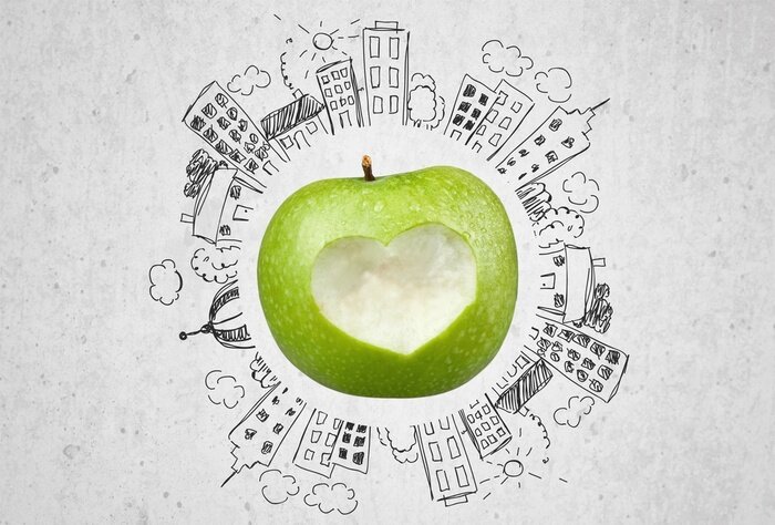 Sticker Grüner Apfel umgeben von Gebäuden