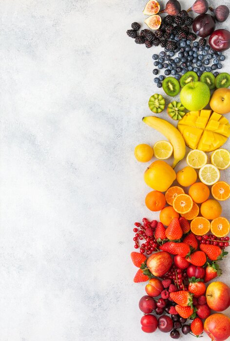 Sticker Rainbow fruits berries background on white. Top view of strawberries blueberries cherries mango apple lemons oranges red currants plums blackberries, selective focus