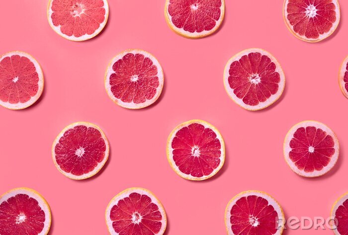 Tapete Grapefruitscheiben auf rosa Hintergrund